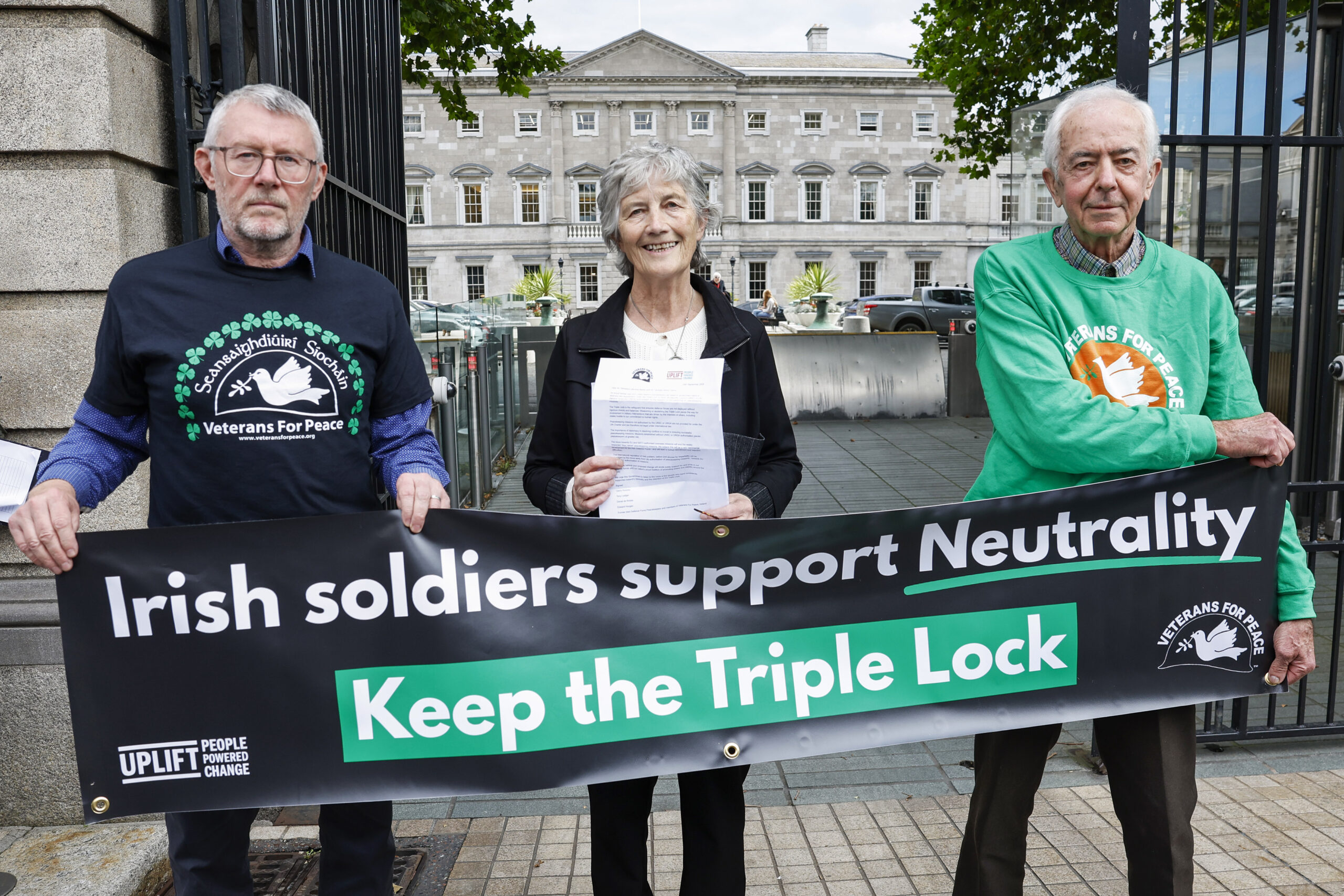 Catherine Connolly (Centre) pictured outside Dáil Eireann with former peacekeepers. She is holding a letter calling on the government to save the Triple Lock.